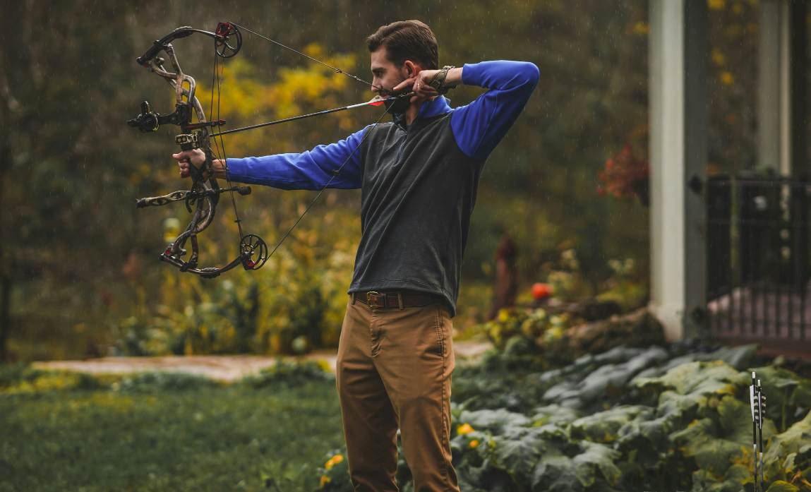 a man is bowfishing in the lake