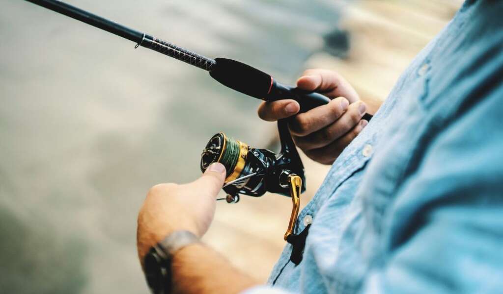 a man is using a fly rod