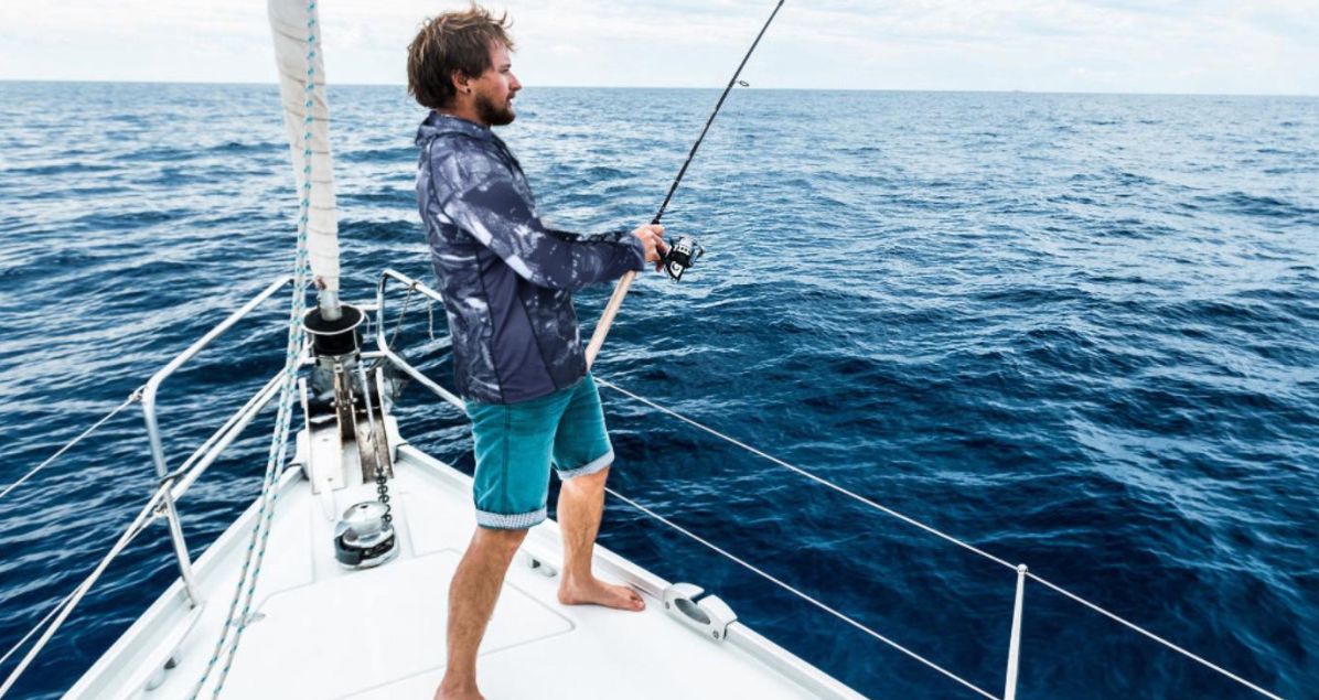 a man wearing fishing shirt on a boat