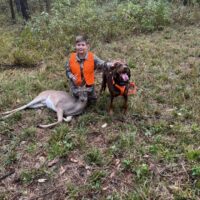 a boy is hunting a deer