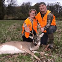 a little girl with her trophy buck