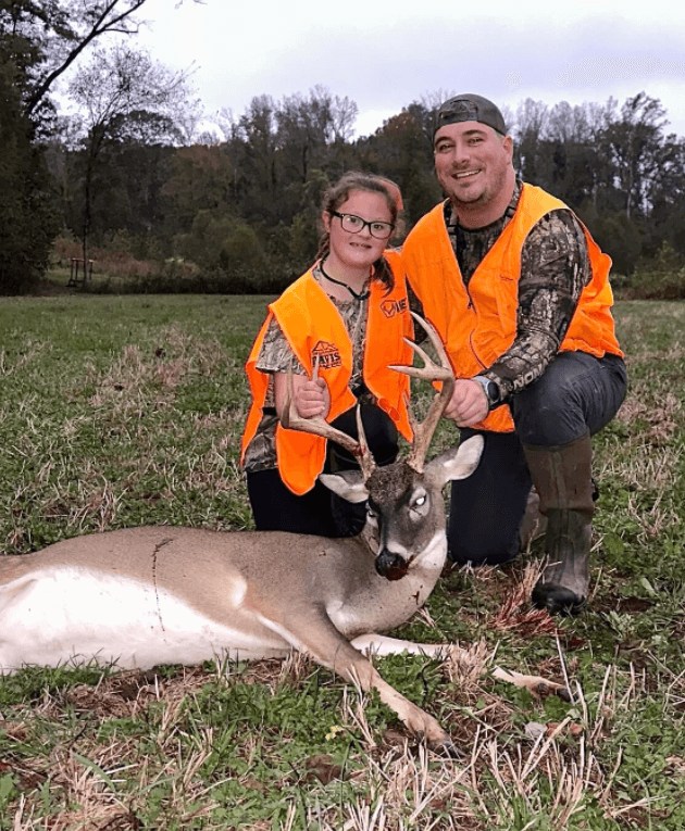 a little girl with her trophy buck